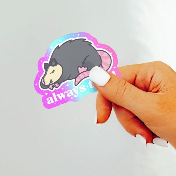 A graphic of Always Tired Possum Sticker available on HeckinMagical.com