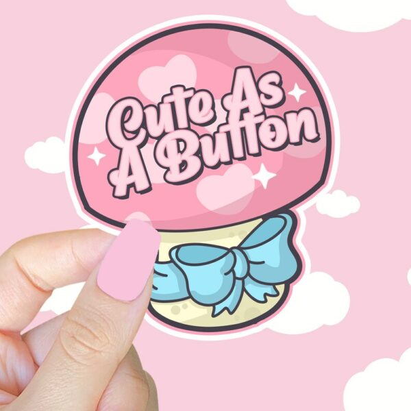 A graphic of Cute As A Button Sticker available on HeckinMagical.com