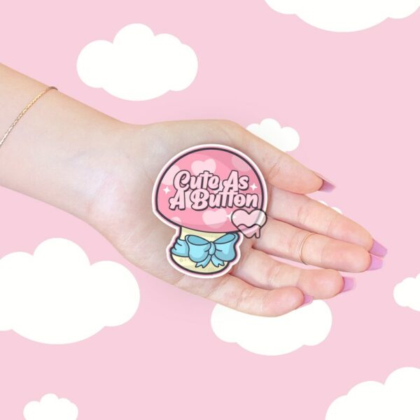 A graphic of Cute As A Button Sticker available on HeckinMagical.com