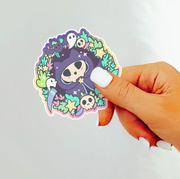 A graphic of Kitty Reaper Sticker available on HeckinMagical.com