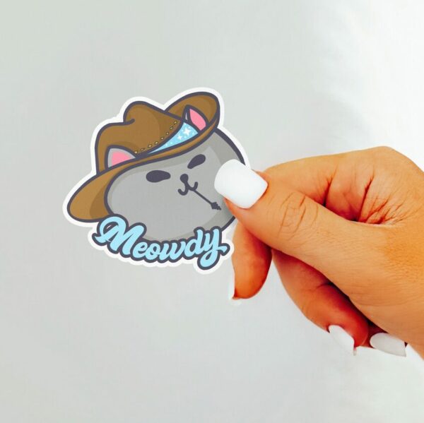 A graphic of Meowdy Meowboy Sticker available on HeckinMagical.com