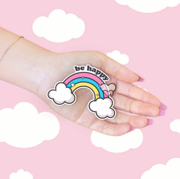 A graphic of Be Happy Rainbow Sticker available on HeckinMagical.com