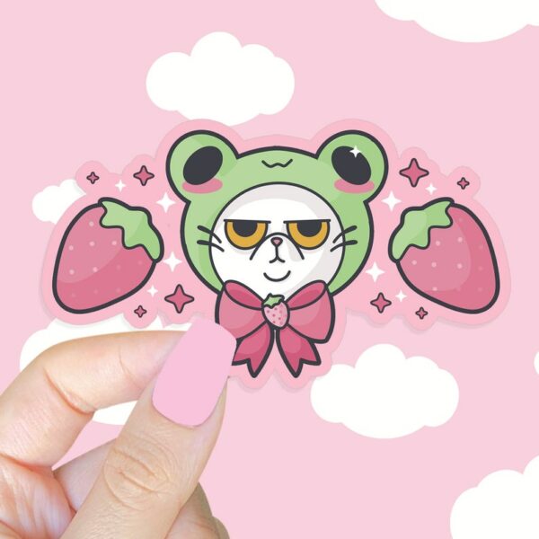 A graphic of Grompy Frog Cat Sticker available on HeckinMagical.com